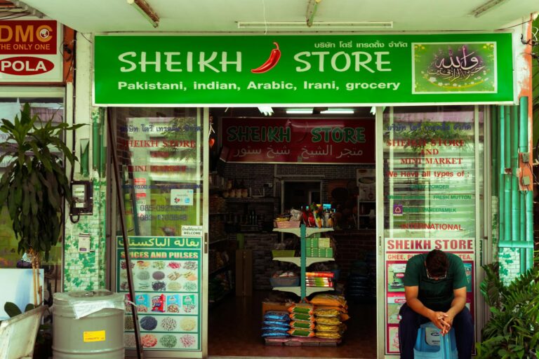 Street view of Sheikh Store offering Pakistani, Indian, Arabic, and Irani groceries in Pattaya, Thailand.